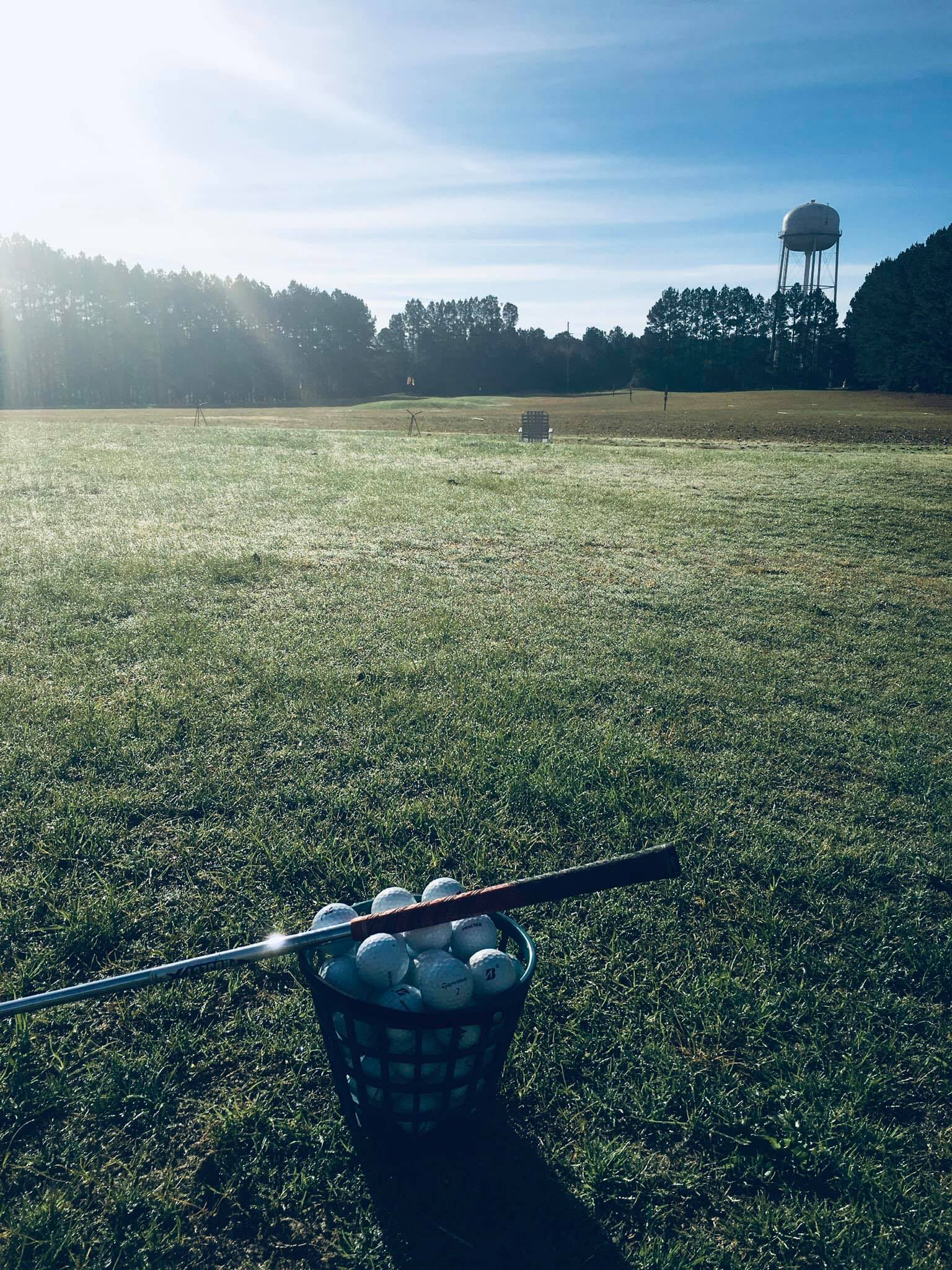 Junior golfer practising at the range